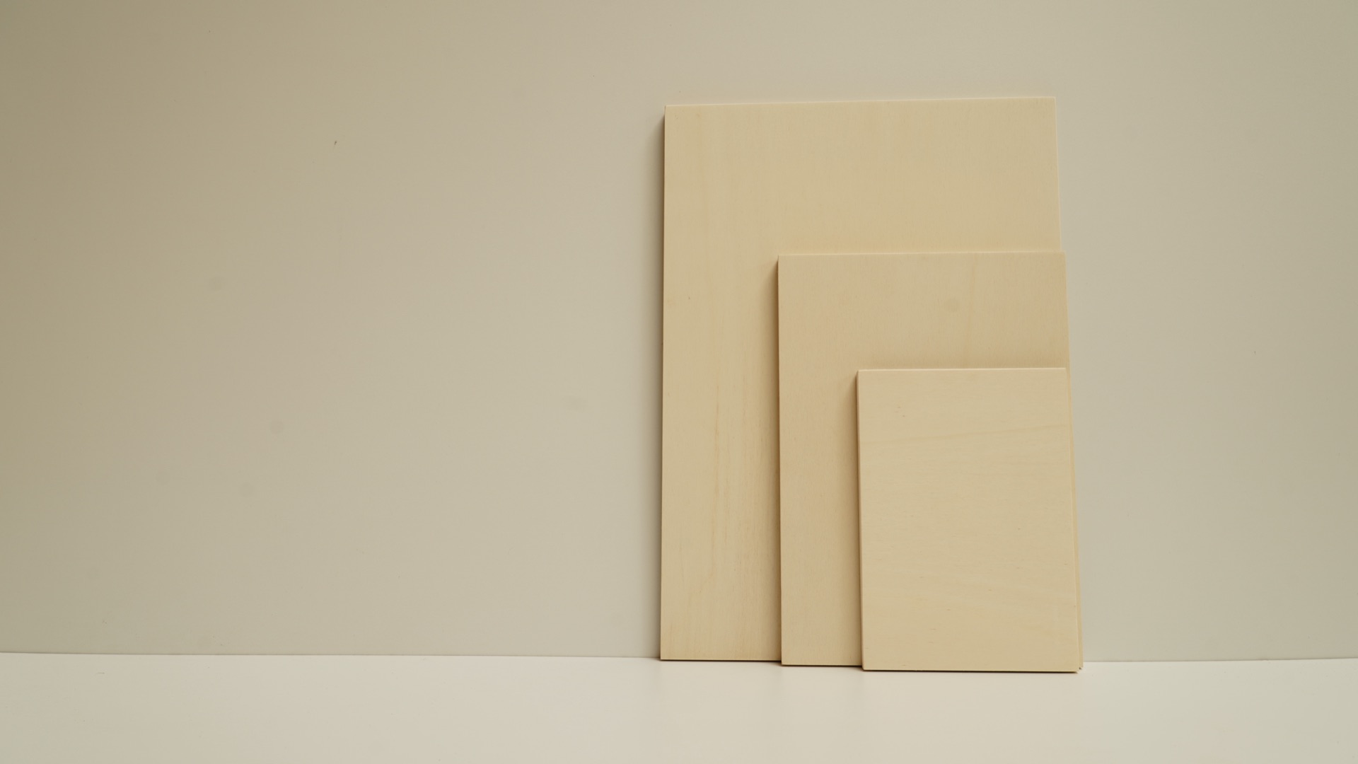 Three Sustainable Ply art boards stacked at staggered angles in commission sizes