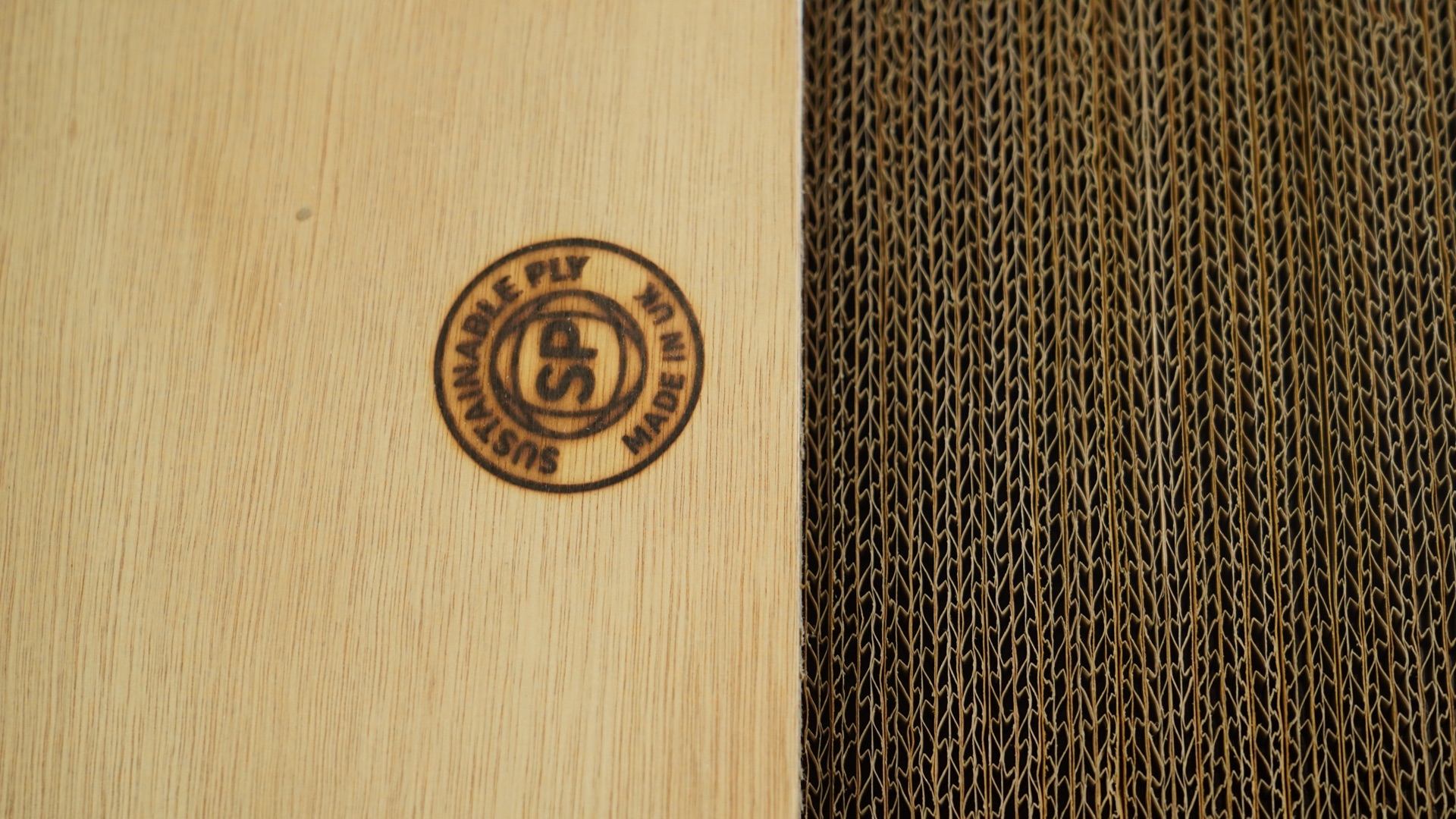 Sustainable Ply SP roundel branded on a finished panel face with the cardboard core visible at the side